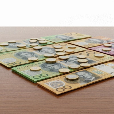 Australian Dollar banknotes and coins arranged neatly on a table, symbolizing financial management